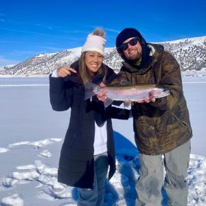 a person holding a fish in the snow