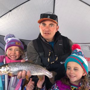 a young boy holding a fish