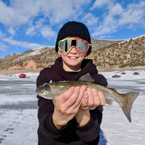 a person holding a fish in the water