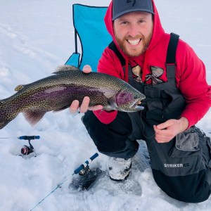 a person holding a fish in the snow