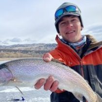 a man holding a fish in the water