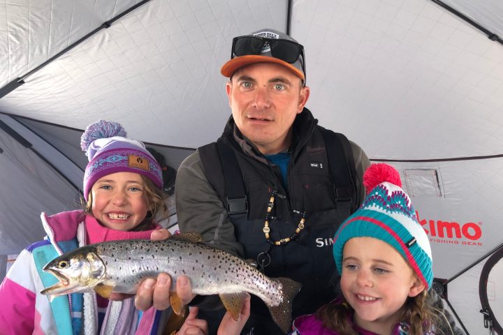 a young boy holding a fish