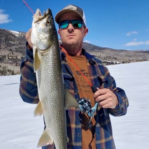 Josh Hendrick a man holding a fish