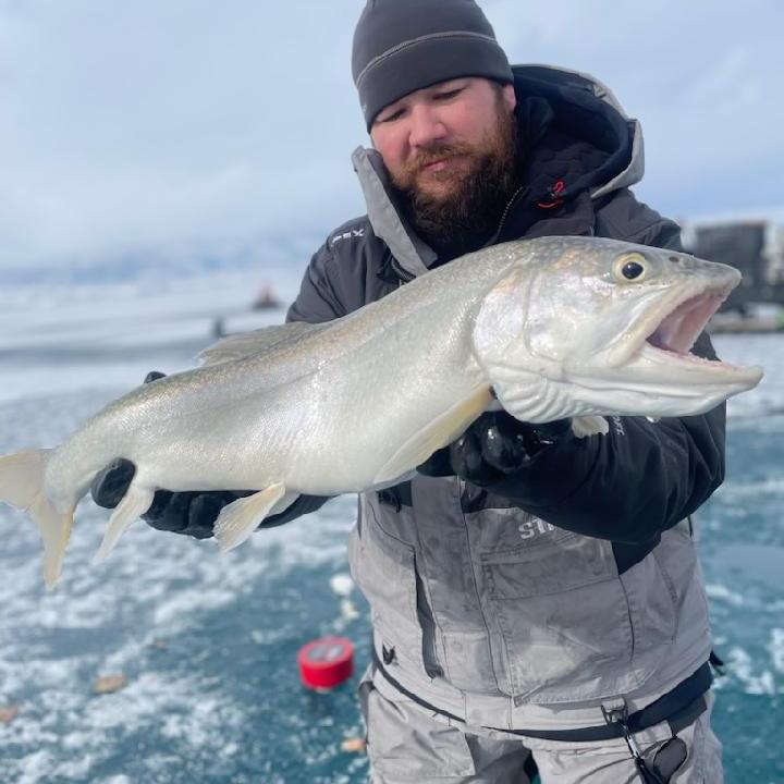 Zack Hendrick a man holding a fish